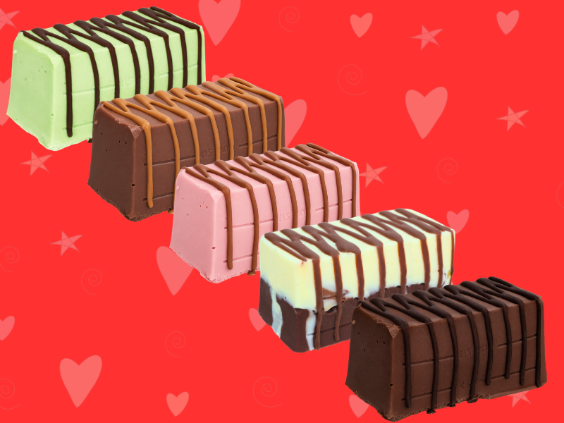 Five rectangular ice cream cakes from the Chunk Selection Box, chocolate-drizzled and fudge-inspired in various flavors, are arranged diagonally on a red heart- and star-patterned background.