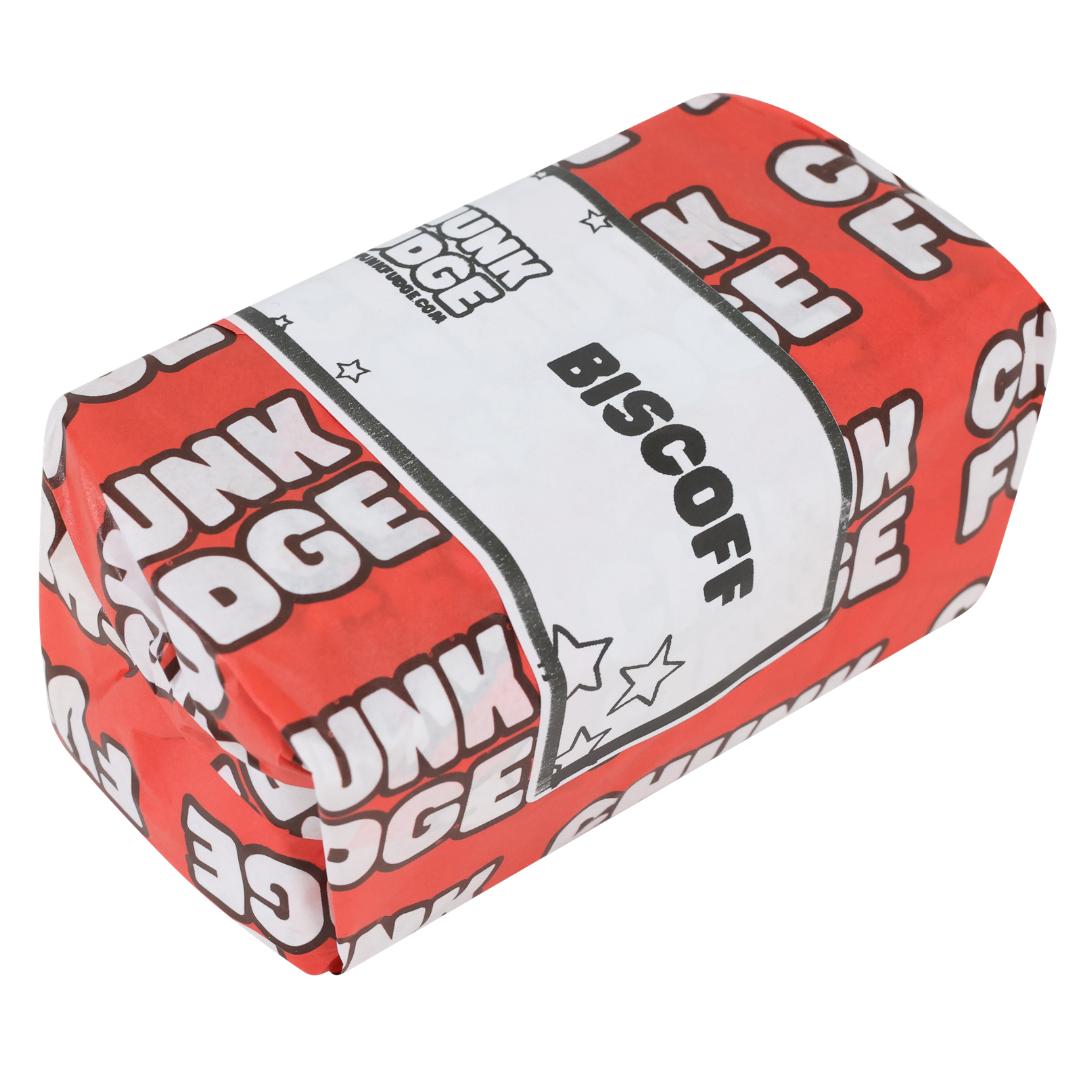 A rectangular block wrapped in red and white paper with "CHUNK FUDGE" and a BISCOFF label, featuring White Choc Biscoff Fudge inspired by classic Lotus Biscoff biscuits and rich caramel chocolate flavor.